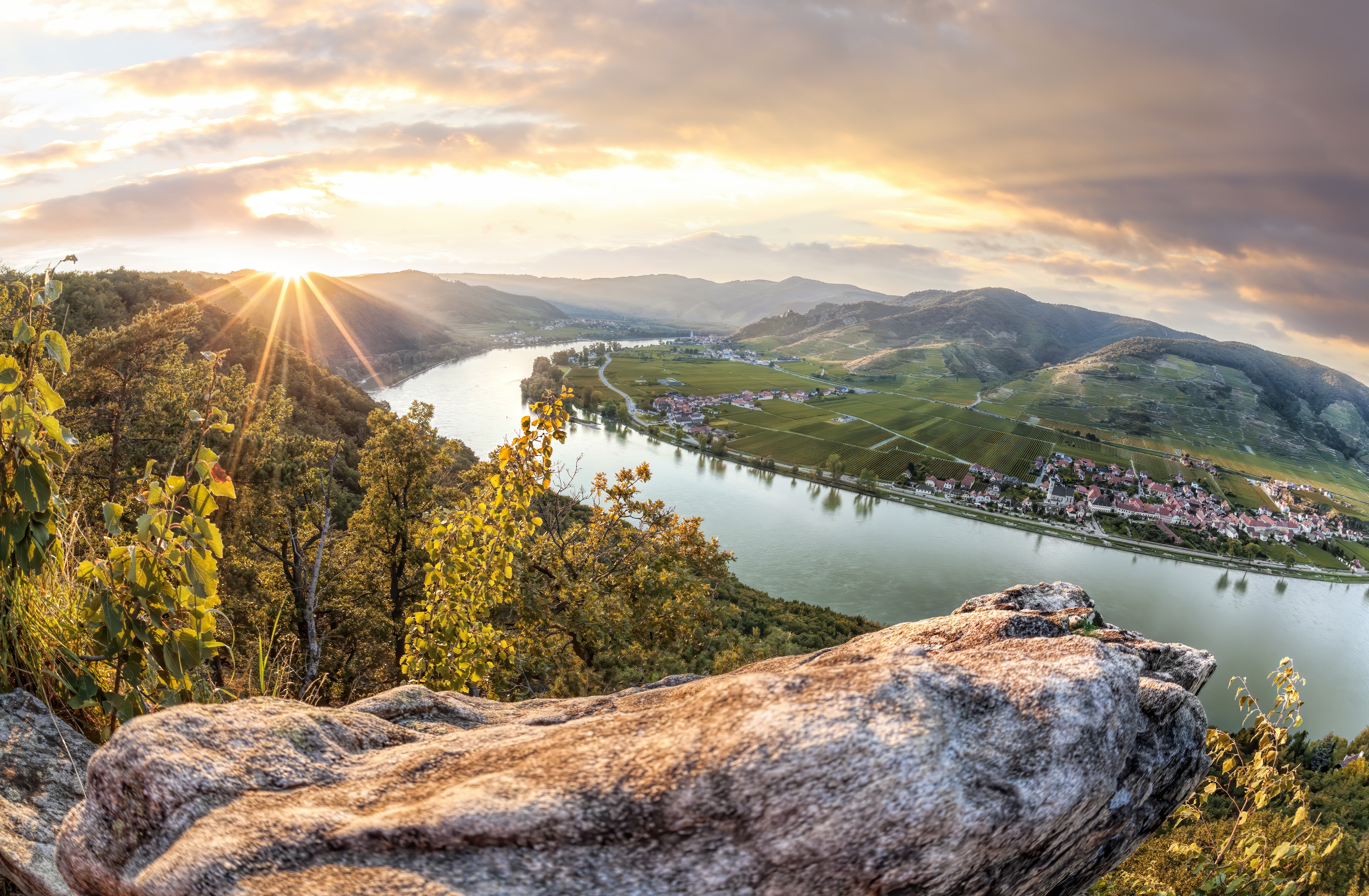 Panorama of Wachau Valley with Danube river at colorful sunset against Duernstein village in Lower Austria.